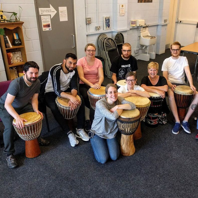 Posing with djembe drums, African drumming class