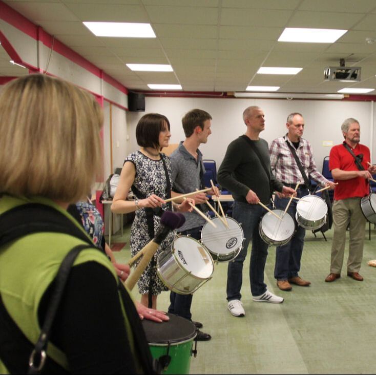 Standing snare and surdo drum players at private event