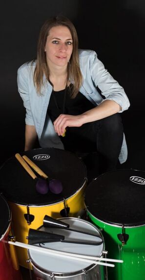 Katie Mallard sitting with Samba Drums